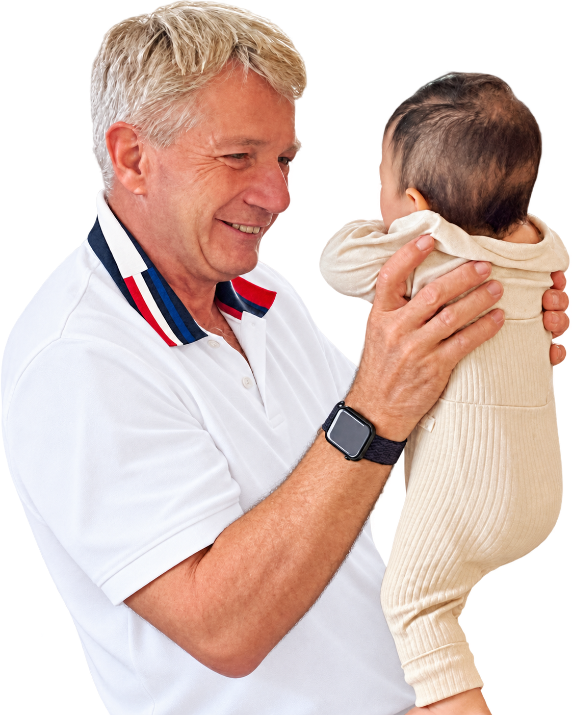 Dr. Peter Henselmann lächelt ein kleines Kind an, das er auf dem Arm hält.